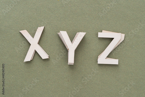 the letters XYZ isolated on a moss green paper background photo
