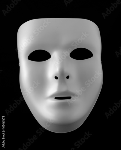 White Blank Face Mask Isolated Against Black Background