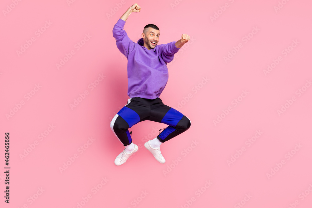 Full size photo of funny millennial brunet guy ride wear hoodie pants shoes isolated on pink background Full size photo of funny millennial brunet guy ride wear hoodie pants shoes isolated on pink background