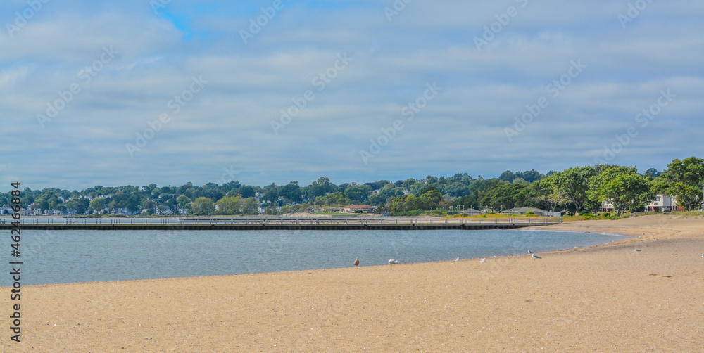 Fototapeta premium A pier on Sand Point Beach at New Haven Harbor on Long Island Sound. West haven in New Haven County, Connecticut