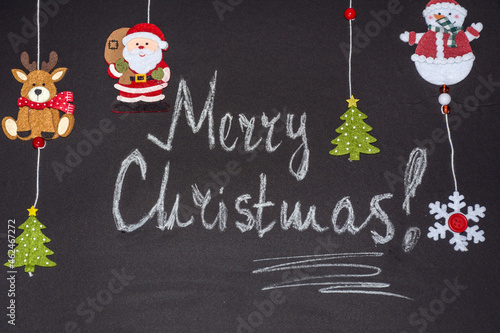 Christmas Greeting Card on a Black Chalkboard with Merry Christmas Text 