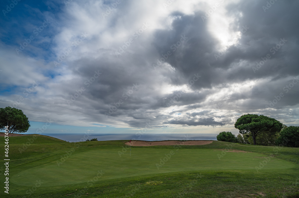 Green nr. 18 with clouds and see at Palheiro golf course on Madeira, Atlantic ocean, Portugal