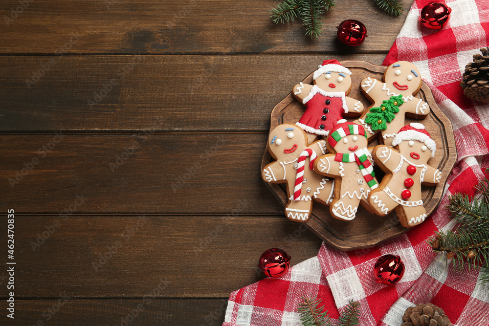 Delicious Christmas cookies and festive decor on wooden table, flat lay. Space for text
