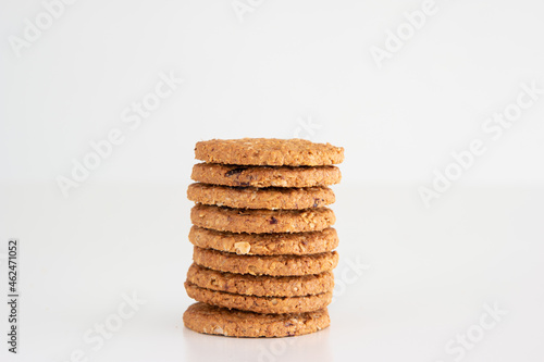 Stack of tasty cereal multigrain raw cookies. Close up studio shot, isolated on white