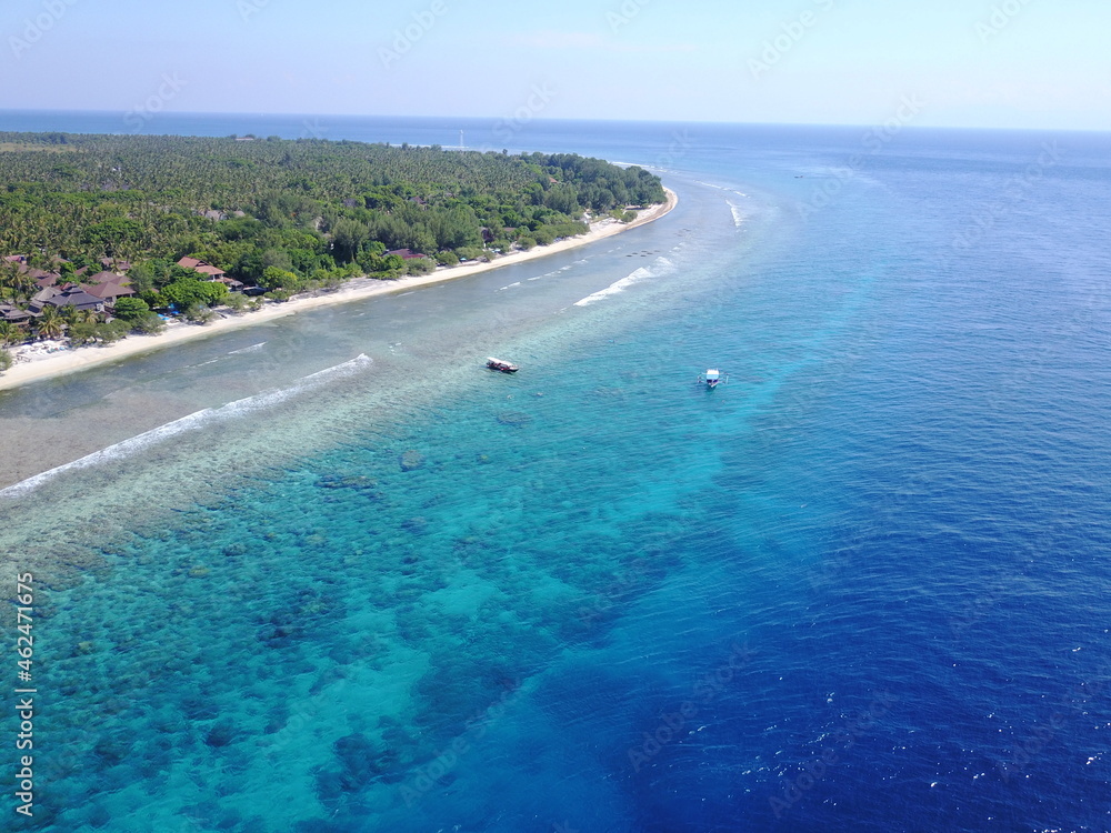 Drone Gili island blue colors boat ship sunny day exotic destination coral corals landscape horizon 