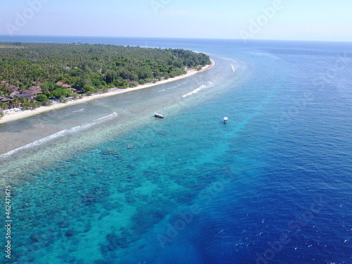 Drone Gili island blue colors boat ship sunny day exotic destination coral corals landscape horizon 