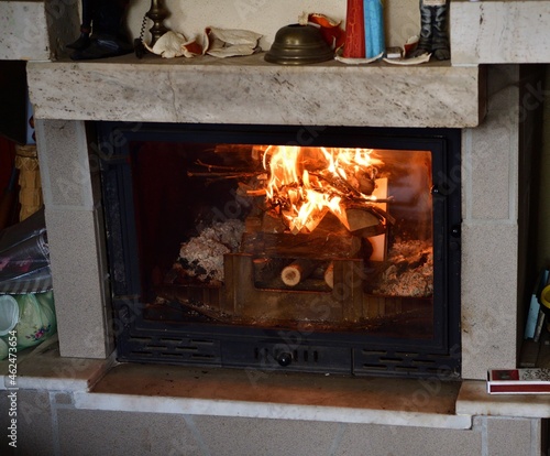 Принти на полотні Flames of a burning fire in a fireplace insert in a cottage