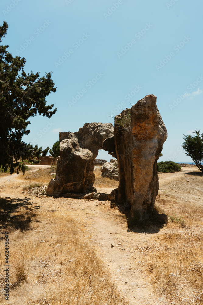 Obraz premium Amazing single rock in the middle of dry meadow. Beautiful Cyprus landscape in the full summer season.