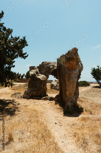 Amazing single rock in the middle of dry meadow. Beautiful Cyprus landscape in the full summer season.