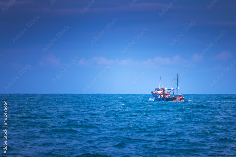 Blue sea waves and sailing cargo ship, scenic view Blue sea waves and sailing cargo ship, scenic view