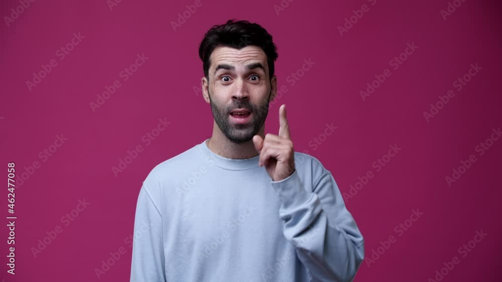 man thinks and comes up with an idea, smiles, and is dressed in blue and pink background man thinks and comes up with an idea, smiles, and is dressed in blue and pink background