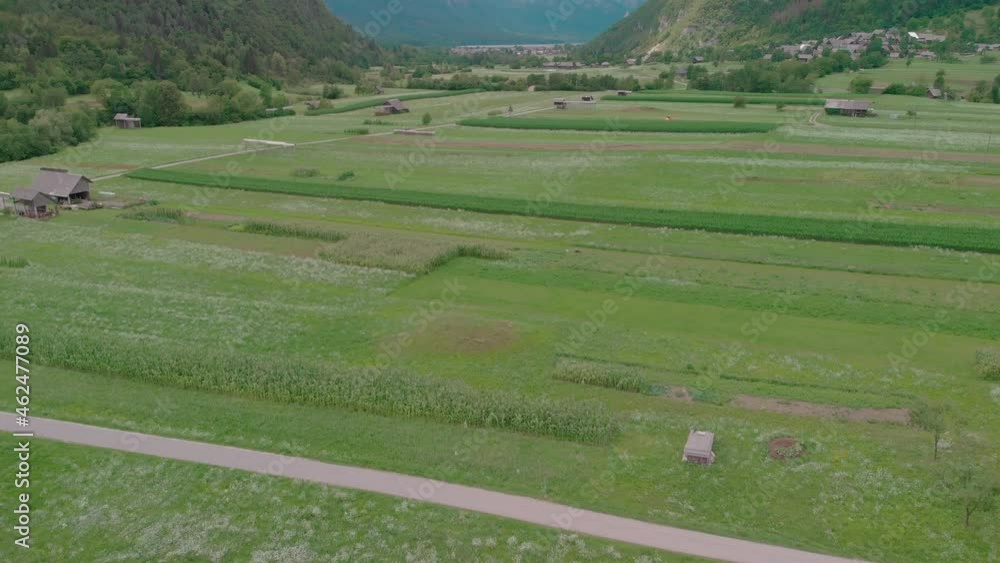 Fields and meadows in valley among mountains aerial view Fields and meadows in valley among mountains aerial view