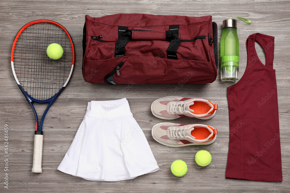 Sports bag and tennis equipment on wooden background, flat lay - obrazy, fototapety, plakaty 