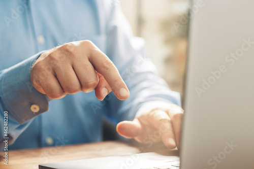 Male hands typing on a laptop keyboard  close-up view