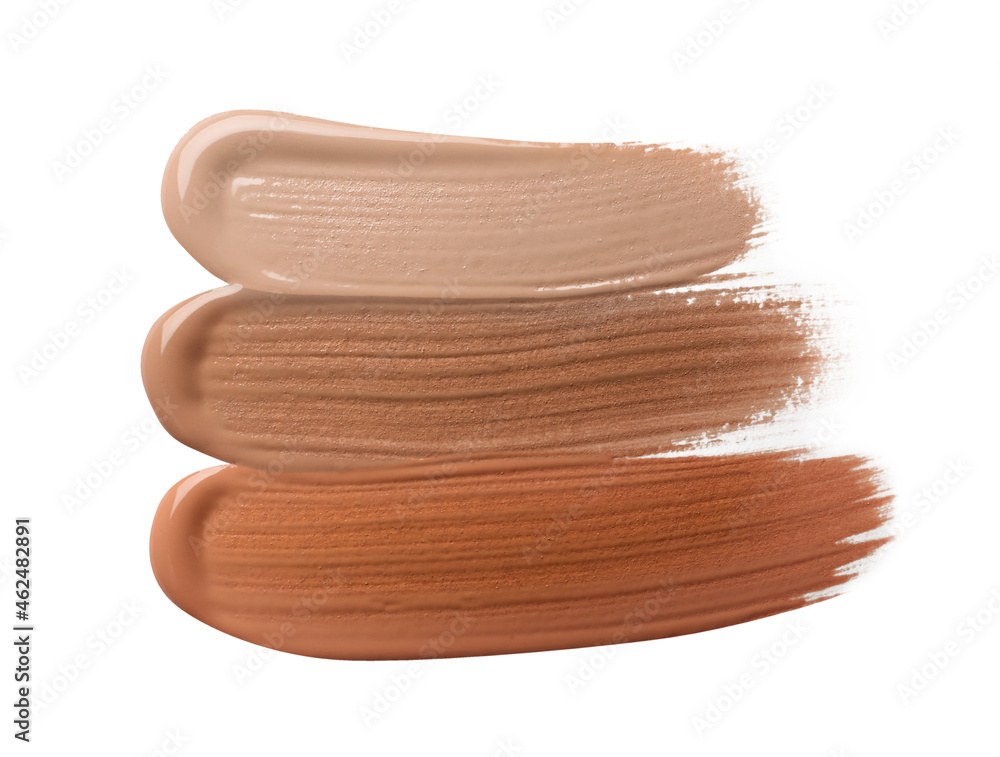 Different shades of liquid foundation on white background, top view Different shades of liquid foundation on white background, top view