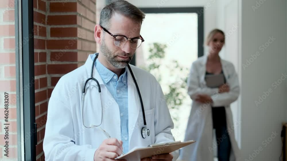 Video of confident female and male doctors talking about medical information in medical consultation. Video of confident female and male doctors talking about medical information in medical consultation.