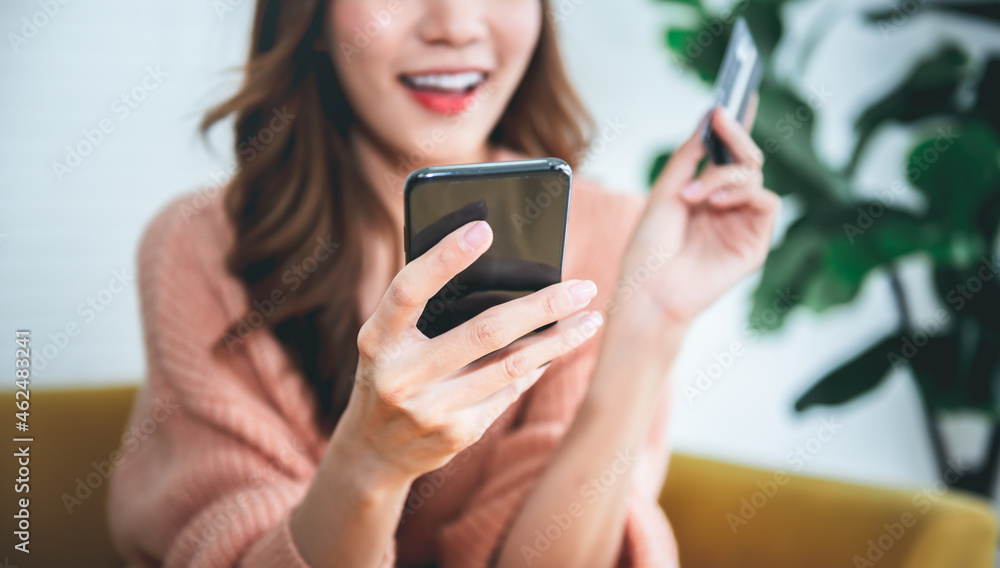 Blurred soft images of Asian attractive woman using mobile phones for shopping online with happy, to business people and shopping online concept.