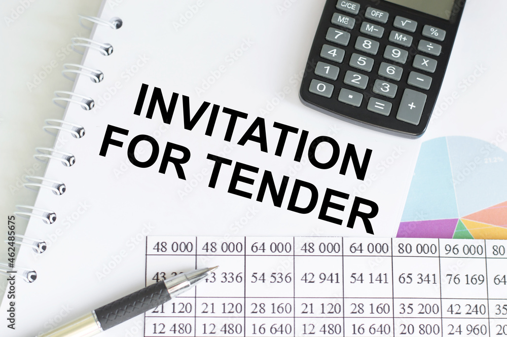 text INVITATION FOR TENDER on a notebook next to a calculator, a pen. text INVITATION FOR TENDER on a notebook next to a calculator, a pen.