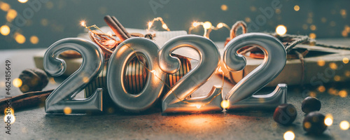 Christmas and New Year card. Number 2022 on holiday background. Christmas lights bokeh background. Banner image for design, web page photo