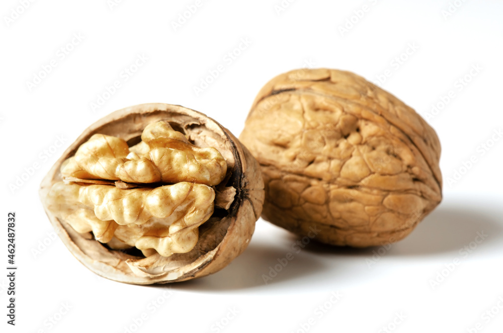 Walnuts on a white background. Nut - a source of vitamins and useful trace elements. Close up. Walnuts on a white background. Nut - a source of vitamins and useful trace elements. Close up.