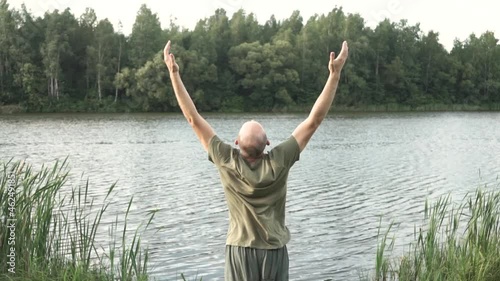 yoga in nature, man in nature raises his hands and reaches for the sky, connection with nature