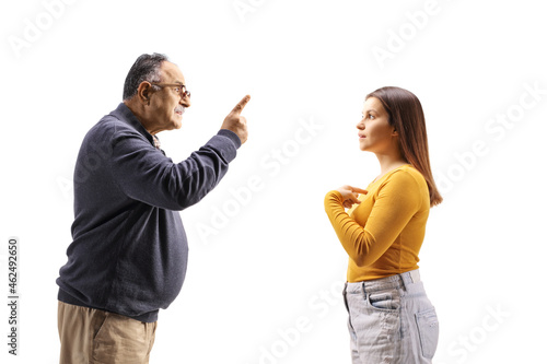 Profile shot of an angry mature man having an argument with a female teenager