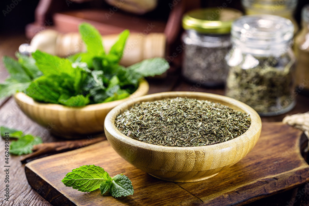 powdered mint leaves, preparation for mint tea in recycled wooden bowl