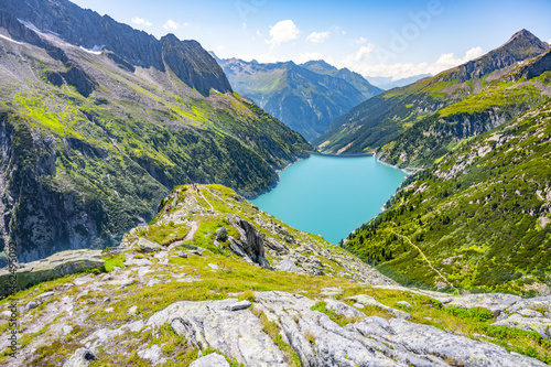 Beautiful alpine walley with azure blue water of Speicher Zillergrundl dam, Zillertal Alps, Austria