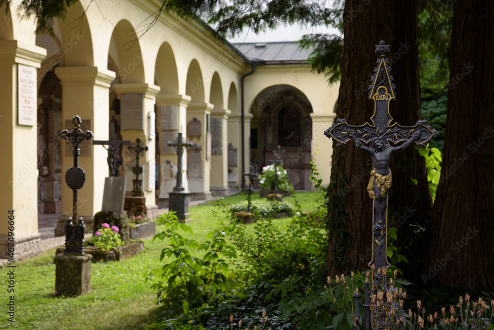 Fototapeta premium Crosses on graves in the cemetery of the late baroque Saint Sebastian's church, Salzburg, Austria