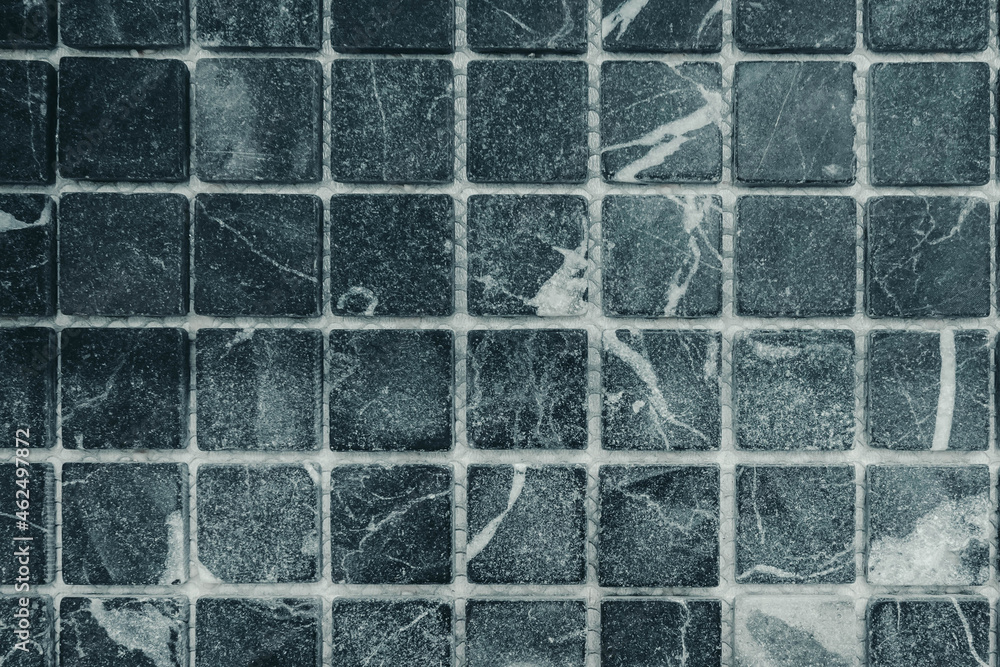 Naklejka premium Photo of a wall in gray square tiles