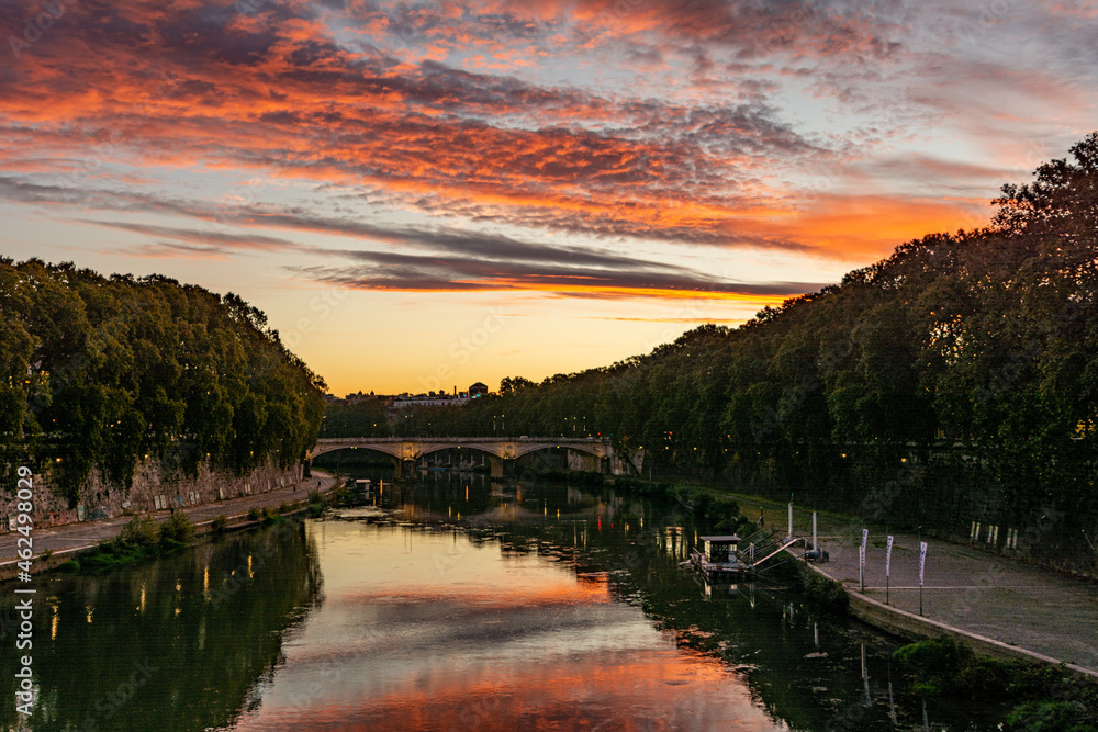 Dramatic sky reflecting in the Tiber River in Rome, Italy during sunrise