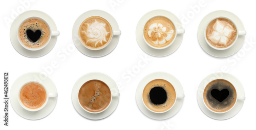 Set with cups of tasty aromatic coffee on white background, top view. Banner design