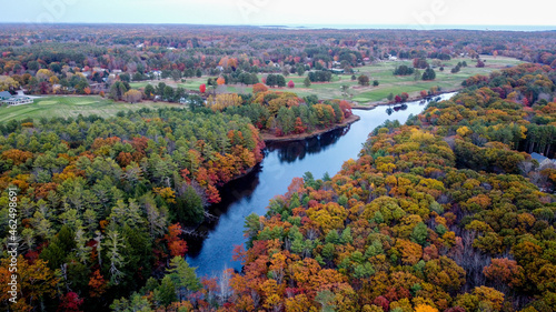 Winding river in small coastal new england maine town - colorful leaves changing - golf course