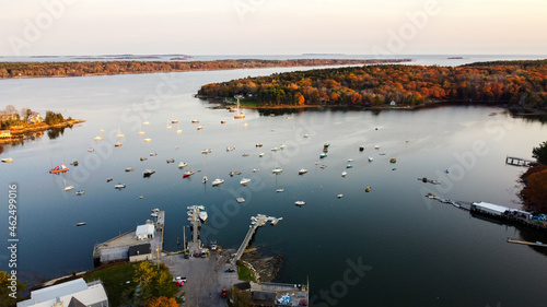 Aerial view of maine coastal harbor - drone picture of lobster boats with the ocean inside a marina sunset - kennebunk maine round pond maine coastal maine