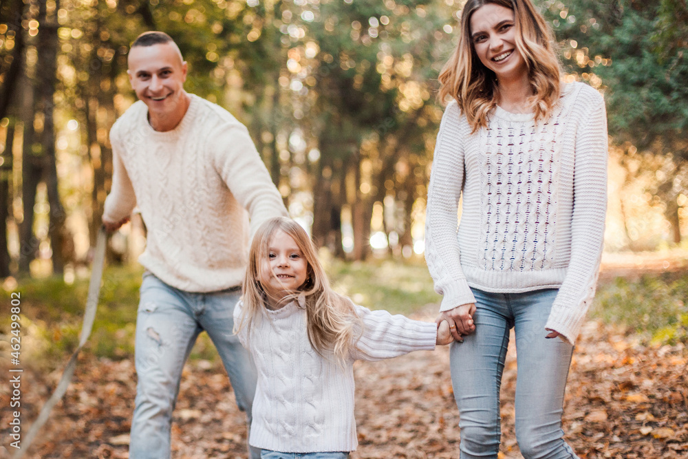 Happy family is having fun walking in the park. Happy family is having fun walking in the park.