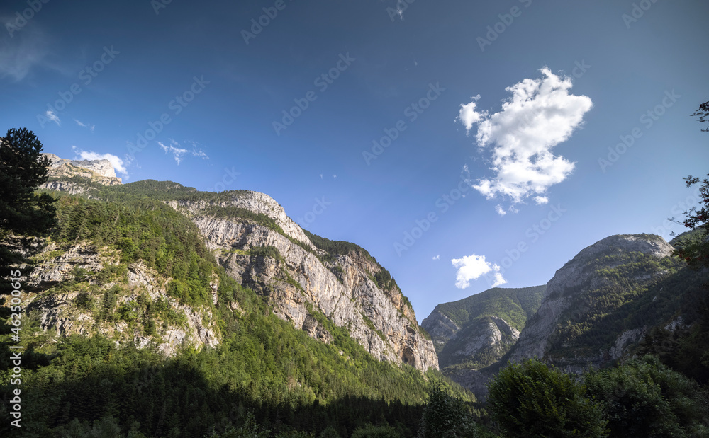Fototapeta premium Clouds passing over monte pedido mountains and river