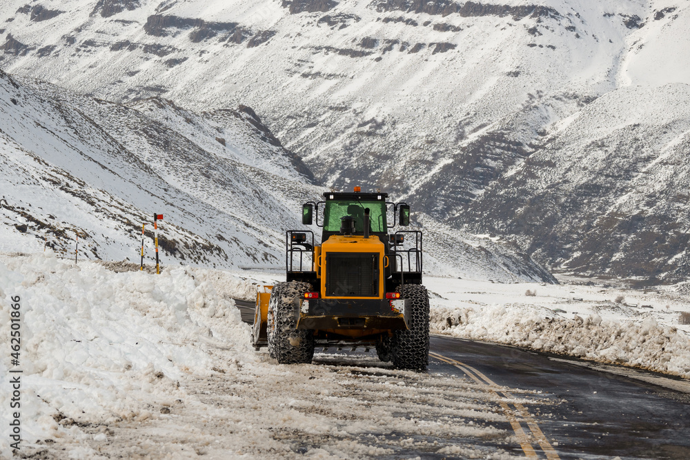 Road machine with chains, removing snow. Road machine with chains, removing snow.