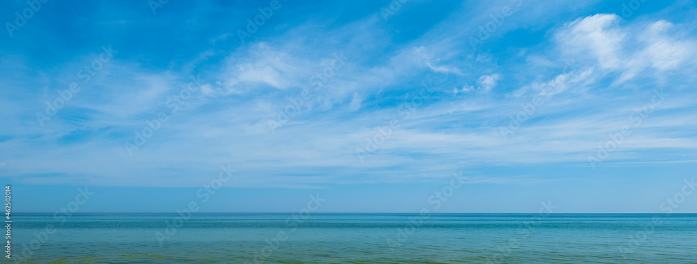 View of the ocean and sky with white clouds. Summer landscape