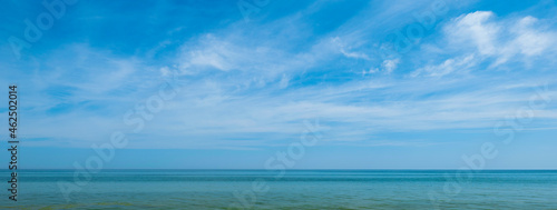 View of the ocean and sky with white clouds. Summer landscape