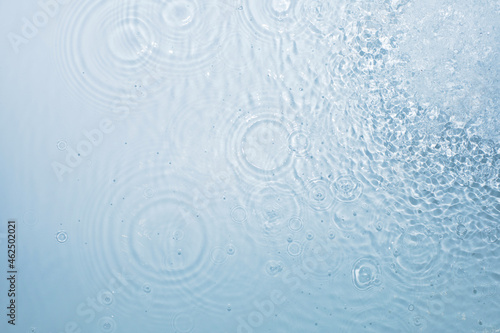 Water blue background with circles from drops spreading in different directions  pattern  top view