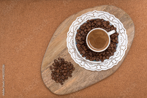 A cup of turkish coffee with roasted coffee beans on wooden table. photo