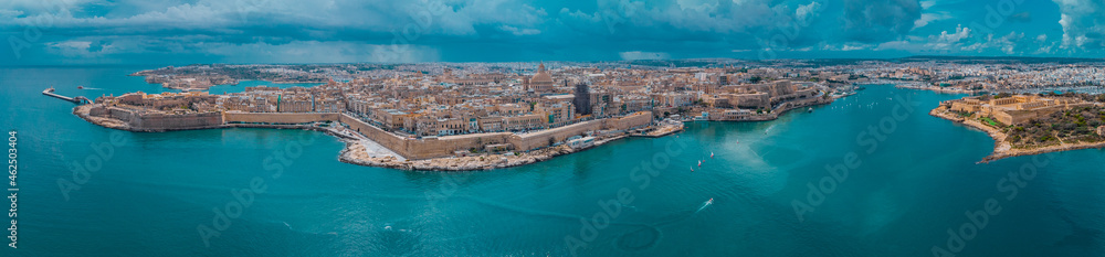 Aerial drone panorama or cityscape of Valetta, capital of malta on a sunny day with storm clouds in the background. - obrazy, fototapety, plakaty 