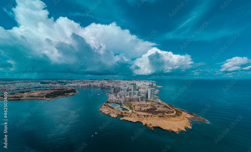 Aerial drone panorama or cityscape of Valetta, capital of malta on a sunny day with storm clouds in the background.