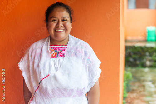Portrait of a mexican woman smiling wearing traditional costume