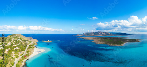 Fototapeta Naklejka Na Ścianę i Meble -  View from above, aerial shot, stunning panoramic view of La Pelosa Beach and the Asinara island bathed by a turquoise, crystal clear water. Spiaggia La Pelosa, Stintino, north-west Sardinia, Italy.
