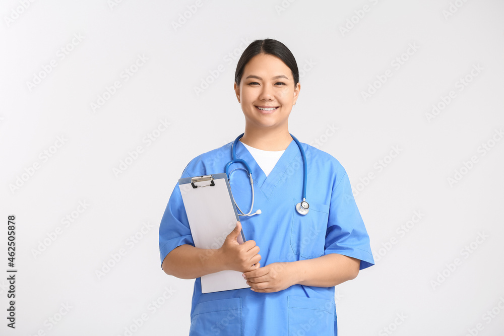 Portrait of female Asian doctor on light background Portrait of female Asian doctor on light background