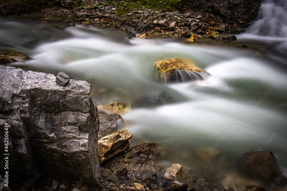 Fototapeta premium water flowing in the forest, long exposure, austrian alps, salzburg, river, austria