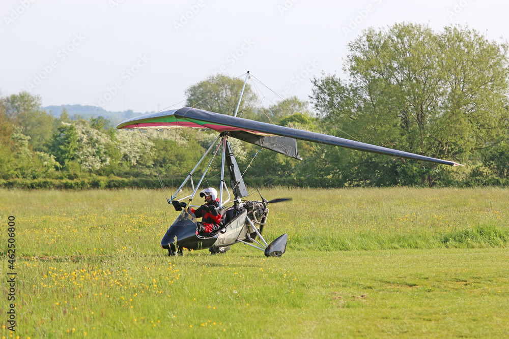 	
Ultralight airplane on a grass airfield	