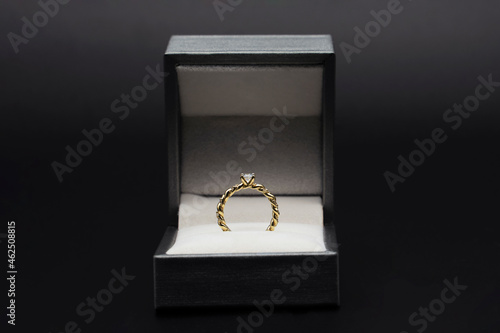 Diamond ring in jewelry gift box on black background