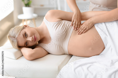 Young pregnant woman having...